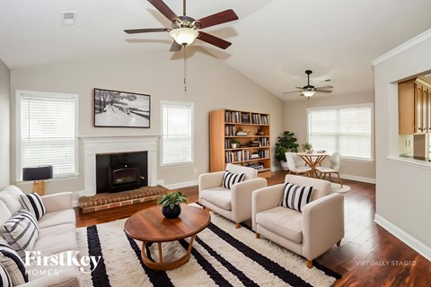 A living room with a fireplace and a bookshelf.