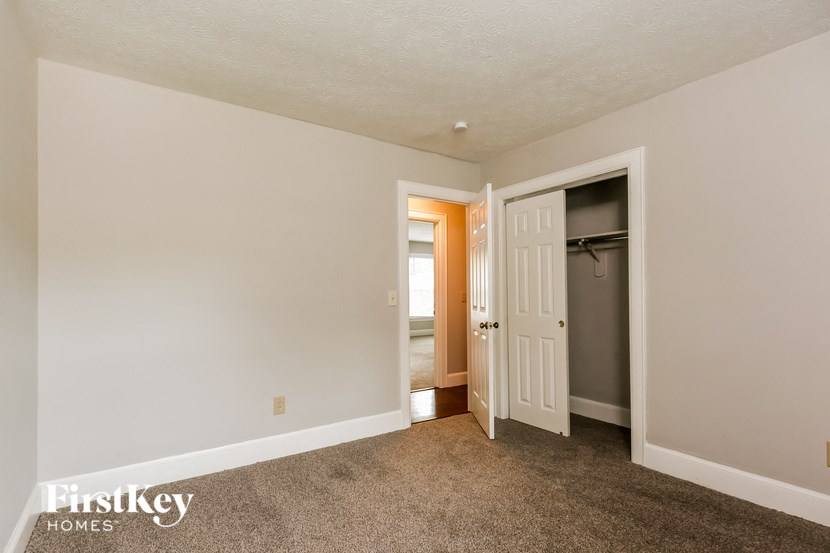 a bedroom with a closet and a door to a hallway