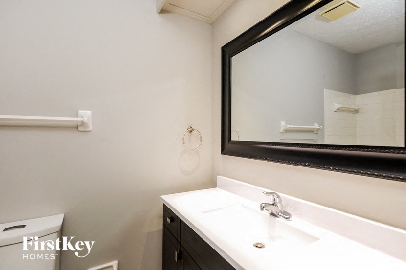 a bathroom with a mirror and a white sink