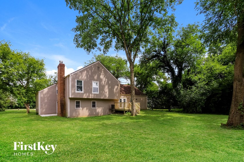 a large house in the middle of a grassy yard