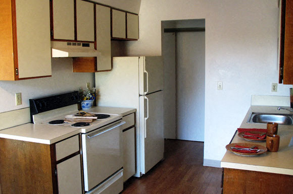 a kitchen with a stove and a refrigerator