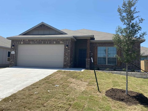 a house with a yard and a garage door