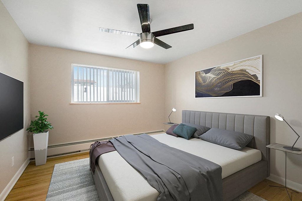 a bedroom with a bed and a ceiling fan
