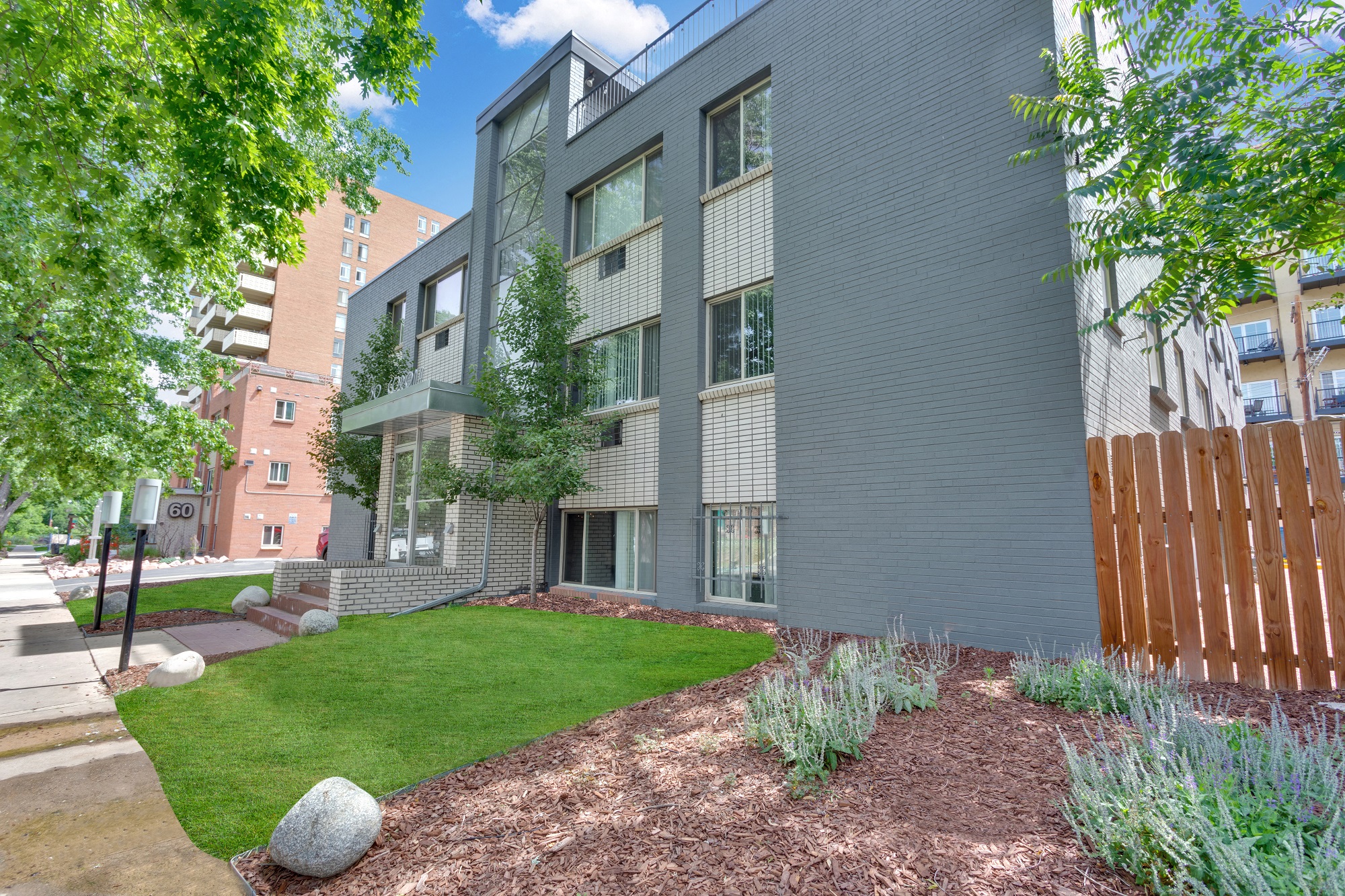 an exterior view of a building with green grass and trees