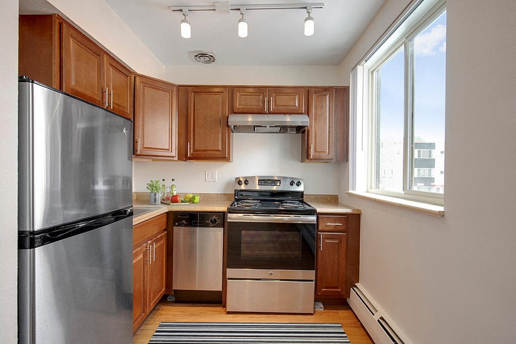 a kitchen with stainless steel appliances and a window