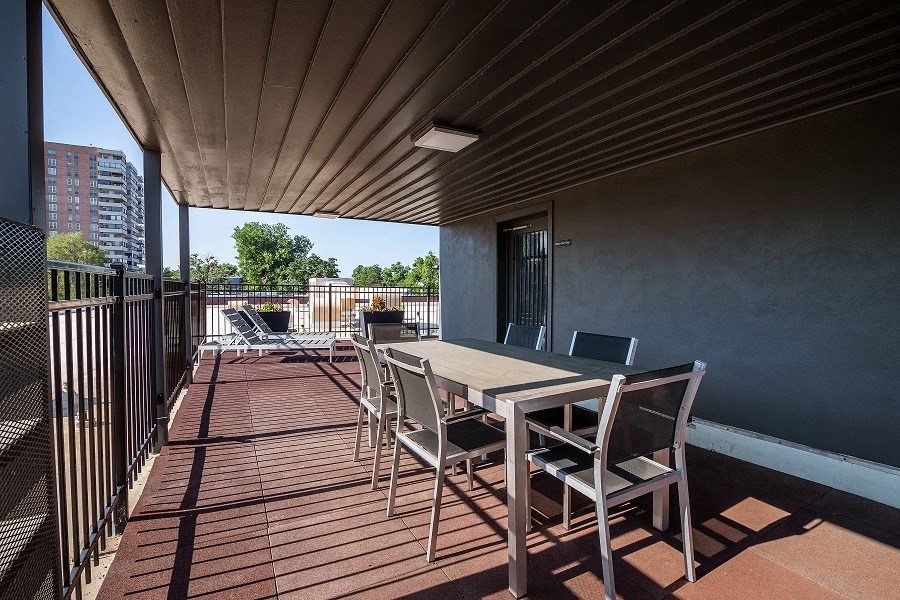 a patio with a table and chairs on a balcony
