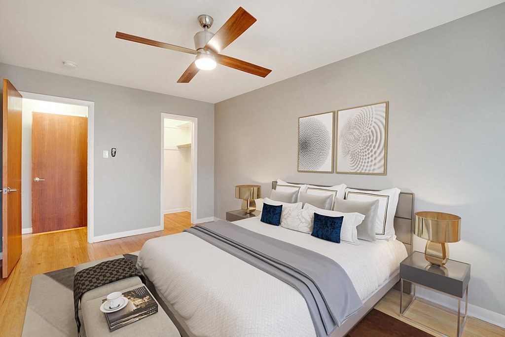 a bedroom with a bed and a ceiling fan