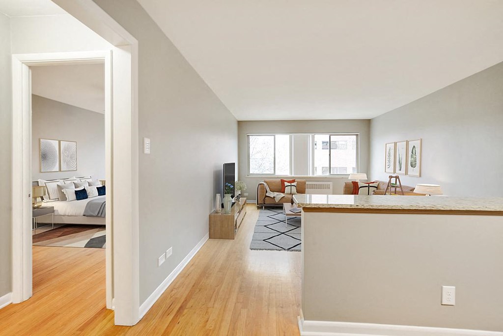 an open living room with a kitchen and a living room