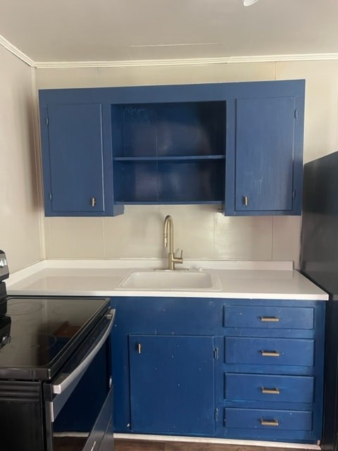 A kitchen with blue cabinets and a black oven.