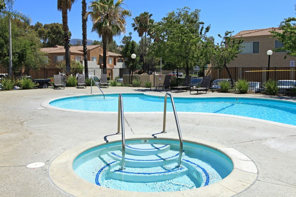 a swimming pool with a fountain in the middle