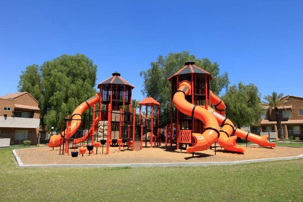 a playground with a slide and other playground equipment