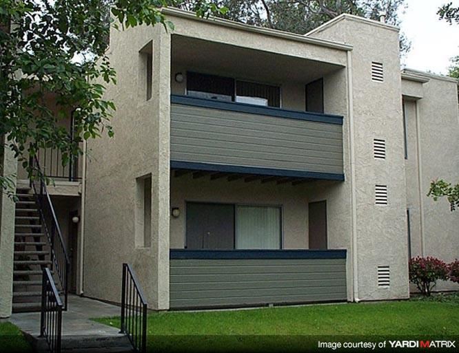 a white house with a yard and a staircase