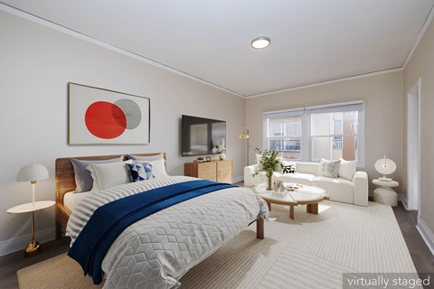 A bedroom with a large bed and a flat screen TV.