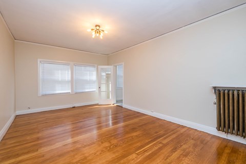 A room with wooden floors and a ceiling light.