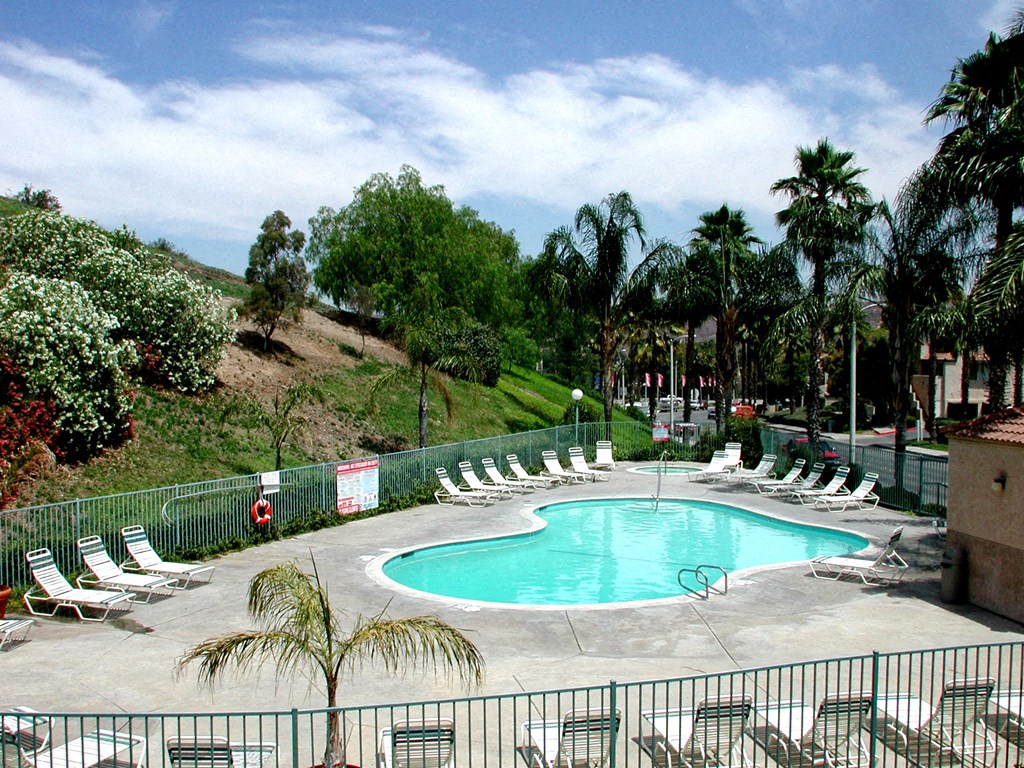 a large swimming pool with chairs around it