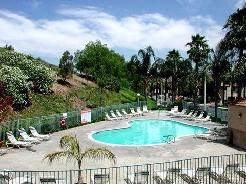 a large swimming pool with chairs around it