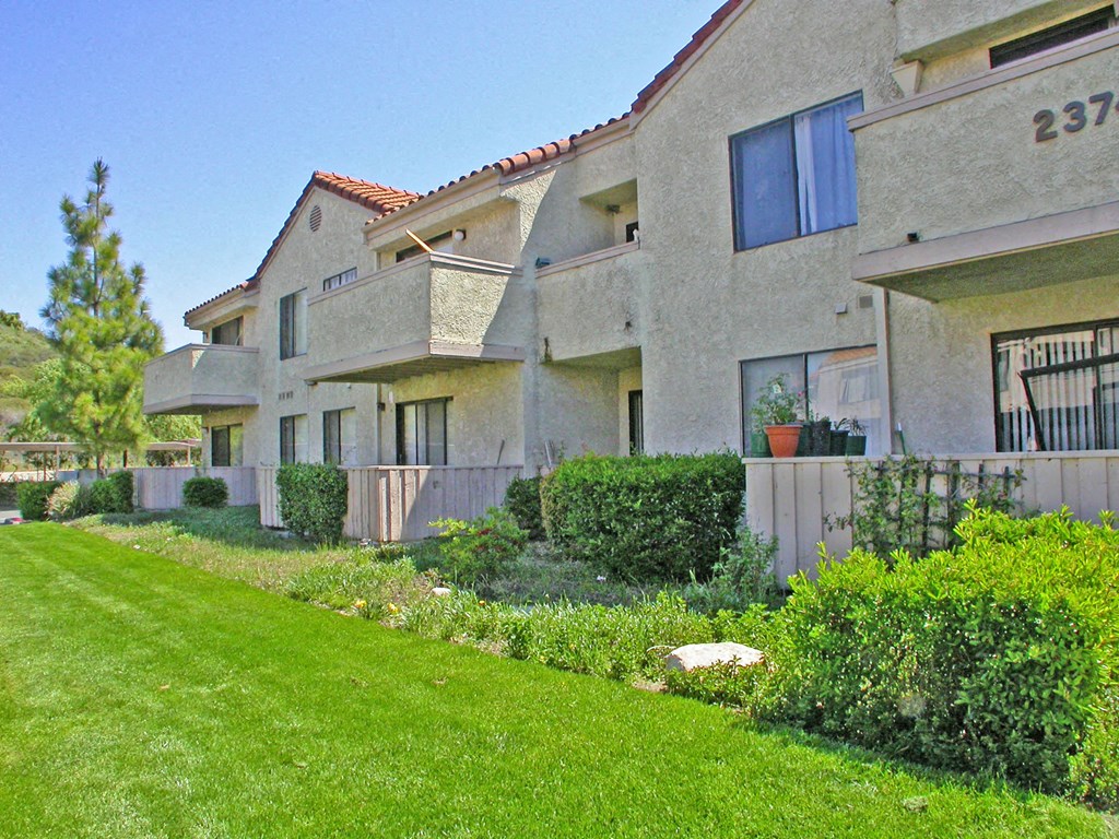 a row of houses with a yard in front of them