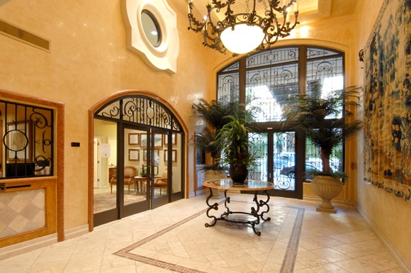 the lobby of a house with large glass doors and a table