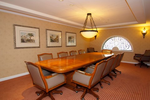 a conference room with a wooden table and chairs