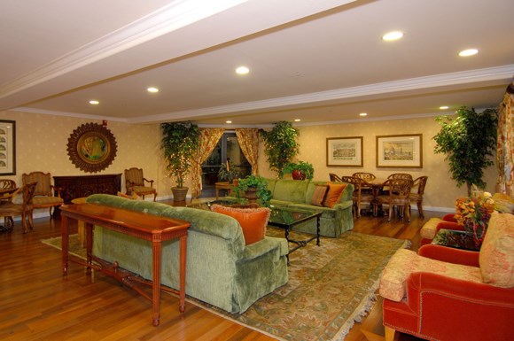 a living room with couches and chairs and a table