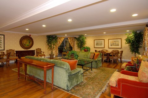 a living room with couches and chairs and a table