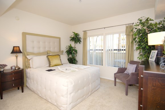 a bedroom with a bed and a desk and a chair