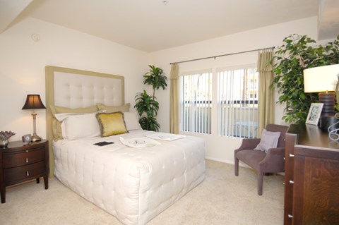 a bedroom with a bed and a desk and a chair