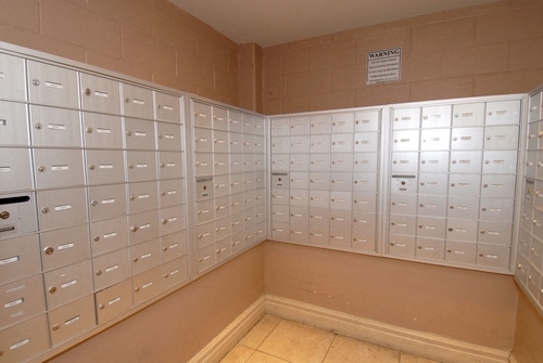 a locker room with lockers on the wall and a bench
