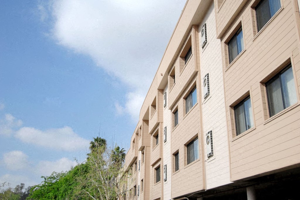 a large building with a blue sky in the background