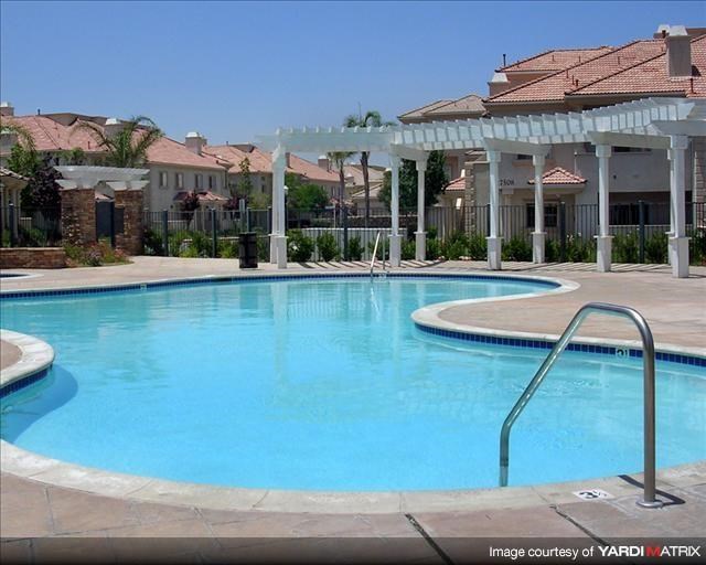a large swimming pool with a white pavilion