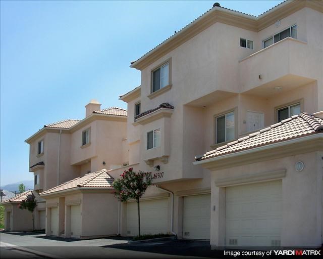 a row of houses with white garage doors