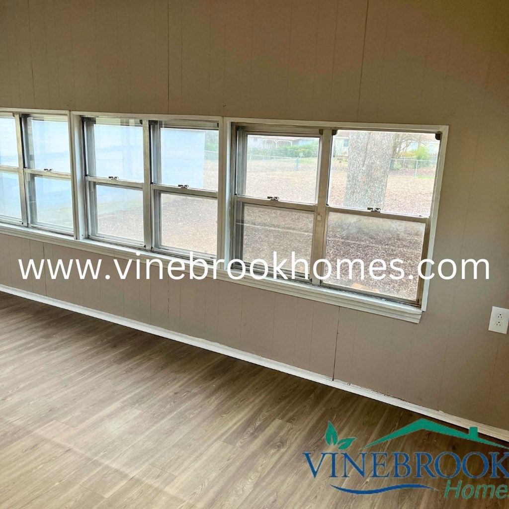 a row of windows in a room with a wooden floor