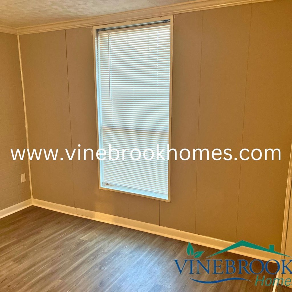a room with a window and a wooden floor