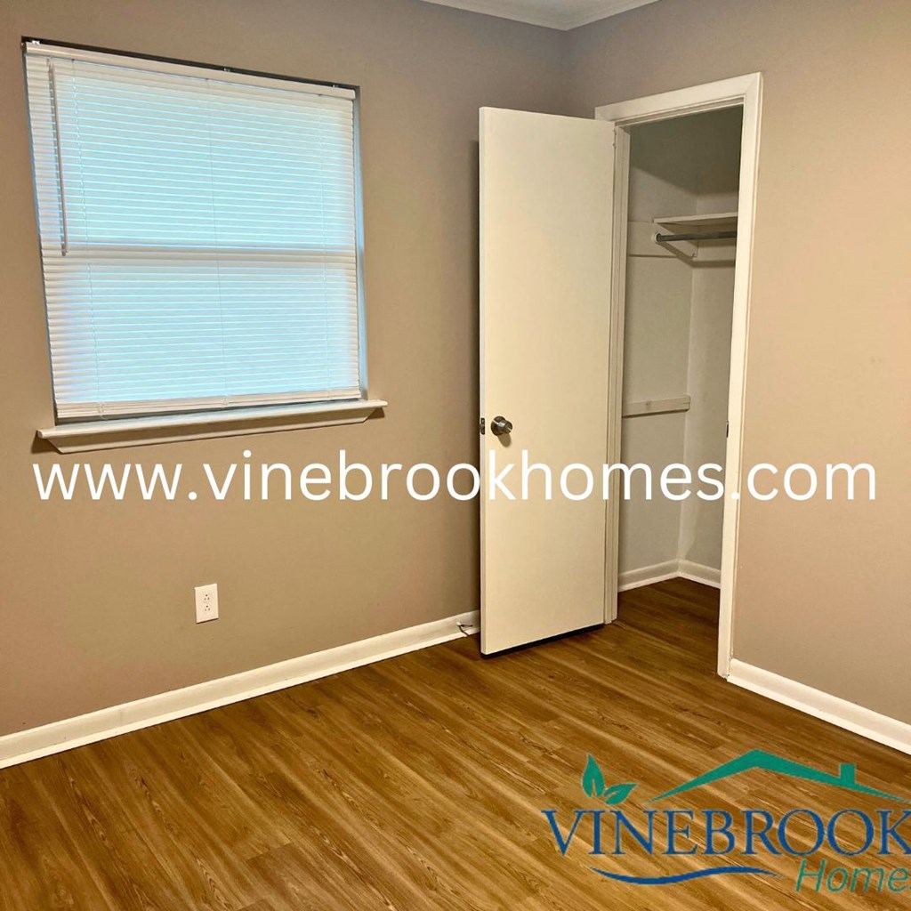 a bedroom with a closet and a door to a bathroom