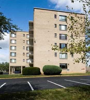 an apartment building in a parking lot
