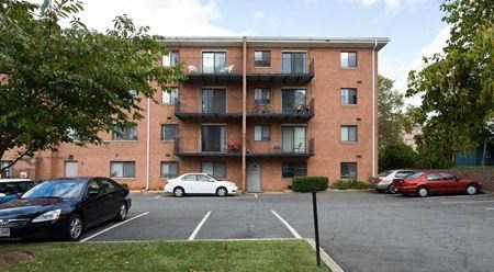 a parking lot with cars in front of a brick building