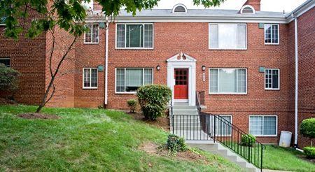a red brick apartment building with a red door