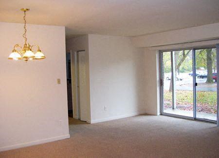 an empty living room with a sliding glass door