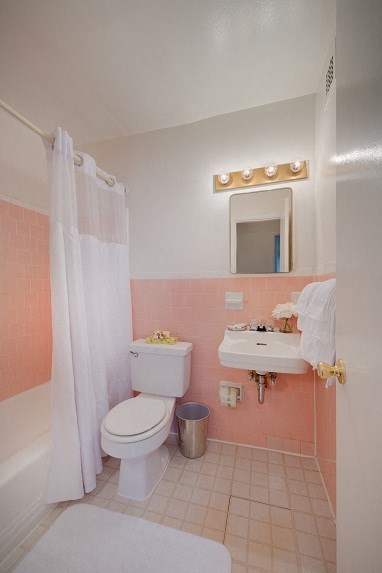 a bathroom with a toilet and a sink and a shower