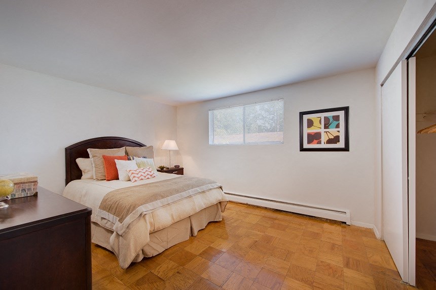 a bedroom with a bed and a window