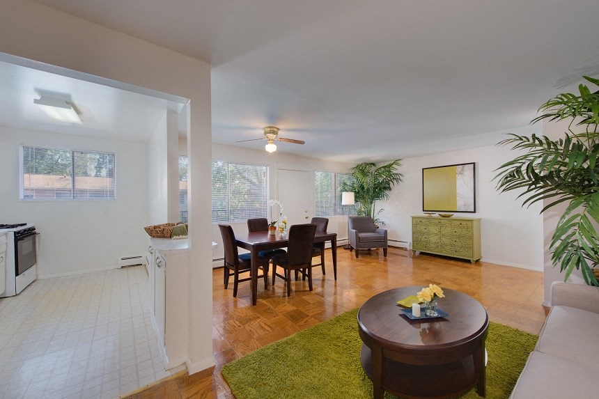 a living room and dining room with a table and chairs