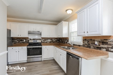 a kitchen with white cabinets and a counter top