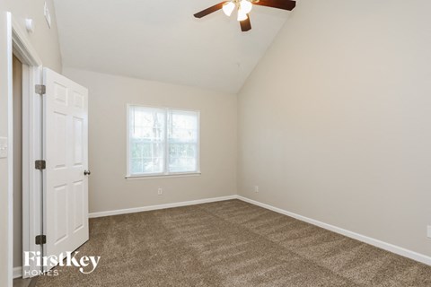 the living room of a home with carpet and a white door