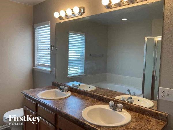 a bathroom with two sinks and a large mirror