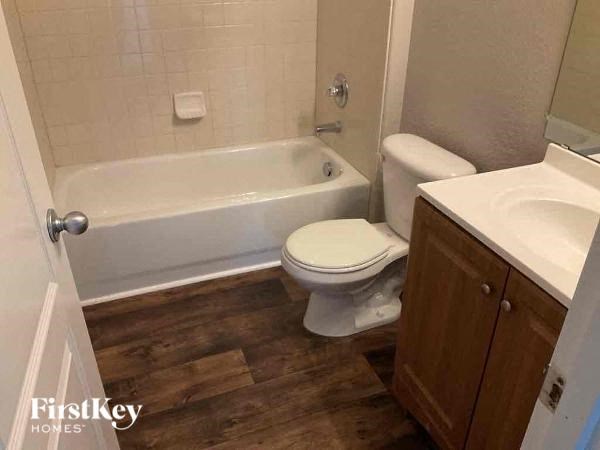 a bathroom with a toilet and a tub and a sink