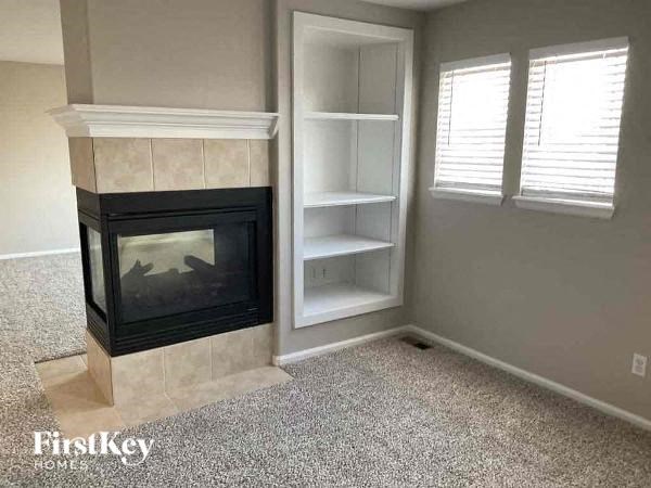a living room with a fireplace and a window