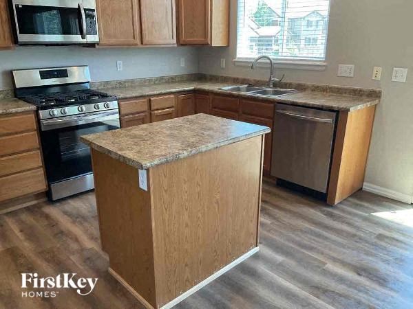 a kitchen with a counter and a stove and a sink