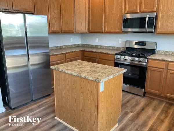 a kitchen with stainless steel appliances and wooden cabinets