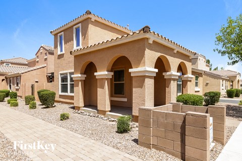 a house with a stone wall in front of it