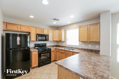 a kitchen with wooden cabinets and black appliances